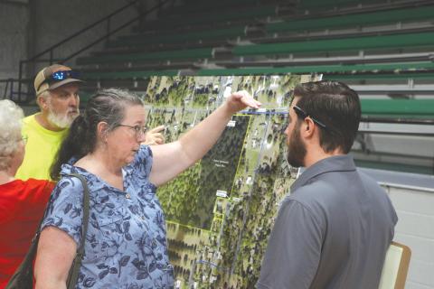 Maureen Bentley (left) speaks with Cory Chandler, an engineer with Landis Evans + Partners during the April 30 presentation about the mixed-use development proposed for Live Oak across from the Suwannee County Coliseum. (MORGAN MCMULLEN/Lake City Reporter)