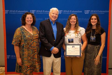 Columbia County UF/IFAS Extension Agent Halie Corbitt (second from right) holds the Environmental Education team award at the 2025 Extension Professional Associations of Florida Symposium. The award went to the Columbia County team, including Heather Futch (left) and Zoie Whitlock (right) as well as Paulette Tomlinson, Erin Harlow, Kalie Picklo, Julia Fulton and the Columbia Master Gardener volunteers. (COURTESY)