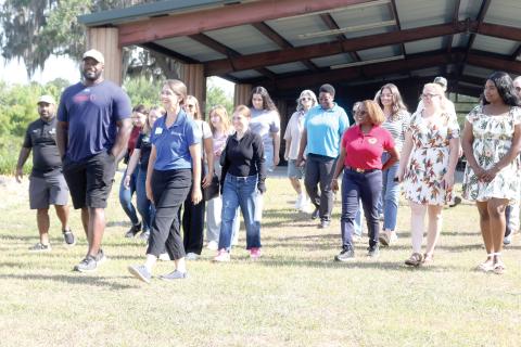 Chris Coleman (from left) and Erin Harlow lead a group of people on a trail tour at Alligator Lake Public Recreation Area on Tuesday morning as part of Economic Development Week activities. (TONY BRITT/Lake City Reporter)