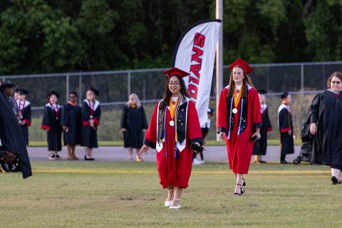 Fort White valedictorian Anais Maldonado and salutatorian Ashley Giambrone lead the Class of 2025 on the field at Arrowhead Stadium on Friday for graduation. (RAY CARPENTER/Lake City Reporter)