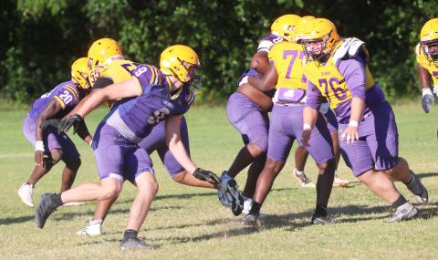 Columbia defensive end Kyten Davis (left) rushes into the backfield as center Zackery Grimes turns to block during Monday's practice. (JORDAN KROEGER/Lake City Reporter)