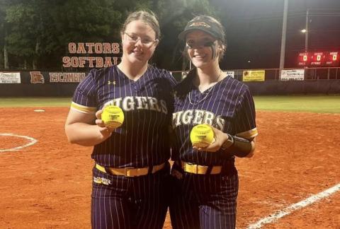 Columbia designated player Josie Raulerson (left) and catcher Emily Delgado show off their home run balls following the Tigers’ 16-0 win over Escambia in the Region 1-4A quarterfinals on Tuesday. (COURTESY)