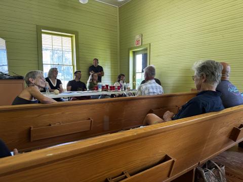 Main Street America senior program officer Lisa Thompson (second from left) and Main Street of Fort White board members listen to community residents during a public roundtable discussion Thursday at the historic train depot in Mayor’s Park. The discussion centered around the community’s vision for the town. (JAMIE WACHTER/Lake City Reporter)