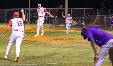 Lafayette pitcher Garrett Taylor (9), Harris Johnson (12) and first baseman Noah Lamb (22) celebrate after the Hornets’ game-ending double play that finished off a 2-1 win over Union County in Game 2 of the Region 3-R finals on Tuesday. (JACK HOWDESHELL/Lake City Reporter)