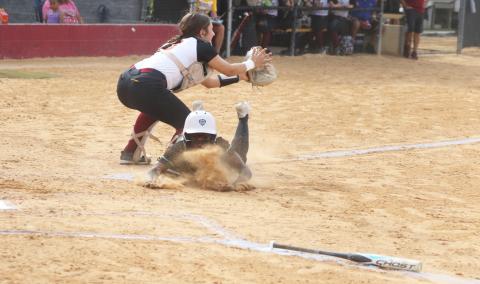 West Nassau catcher Vida Kersey is called for obstruction as Suwannee runner TT Hill slides into home plate for the game-winning run in the top of the eighth inning of Friday’s Region 1-3A quarterfinal. (MORGAN MCMULLEN/Lake City Reporter)