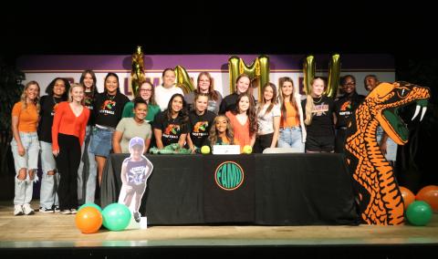 Columbia outfielder Sakiya Merriex (sitting) is surrounded by teammates after signing her letter of intent to play college softball at Florida A&M on Friday. (JORDAN KROEGER/Lake City Reporter)