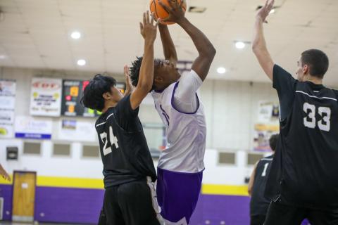 Columbia guard Murkail Cray tries to get a shot off between Buchholz defenders on Thursday. (BRENT KUYKENDALL/Lake City Reporter)