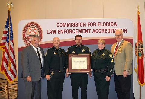The Columbia County Sheriff’s Office received its reaccreditation status June 19 at the FLA-PAC Conference in Orlando. Receiving the recognition for the CCSO were Chief Deputy Katina Dicks (second from left), Sgt. James Cason (middle) and Sgt. Amy Geier (second from right). (COURTESY)