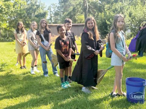 4-H campers Lumen Jimenez (from let), Amelia Mears, Kenleigh Markham, Carter Jordan, Emerson Coleman, Penelope Regar and Heaven Marton have broom practice in preparation for playing Quadball. (PHOTOS COURTESY UF/IFAS COLUMBIA COUNTY EXTENSION)