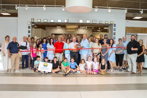 Marc and Paul Vann, co-owners, cut the ceremonial ribbon to celebrate the grand re-opening of Vann Carpet One Floor and Home on Thursday. The Vann’s are joined by family, friends, employees, Lake City and Lake City-Columbia County Chamber of Commerce officials. (COURTESY LAKE CITY-COLUMBIA COUNTY CHAMBER OF COMMERCE)