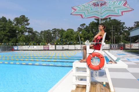 Emma Pitman, a lifeguard at the Jared Allison Aquatic Complex, watches over the pool Monday following a ribbon cutting for the revamped complex. (TONY BRITT/Lake City Reporter)