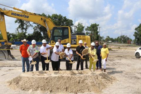 Past and current local officials along with affordable housing and construction officials Ron Williams (from left), Everett Phillips, Troy Wimberly, Lester McKellum, Michael Allan, Mary McKellum, Noah Walker, Steve Auger, Chevella Young, James Carter and Tammy Harris pitch shovels of dirt for the ceremonial groundbreaking of the Sweetwater Phase II apartments on Tuesday morning. (TONY BRITT/Lake City Reporter)