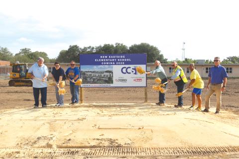 Keith Couey (from left), Hunter Peeler, Roger Little, Keith Hudson, Fred Gaylard, Scharlotte Stewart and Todd Widergren toss soil to commemorate the official beginning of construction of the new Eastside Elementary School. The groundbreaking ceremony took place on Wednesday morning amid construction crews beginning the first stages of demolition work at the school. (TONY BRITT/Lake City Reporter)