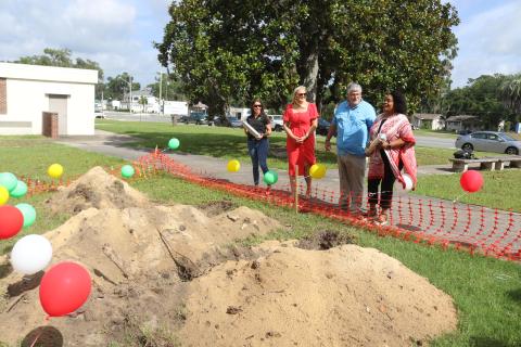 Five Points Elementary School Principal Brandi Keen (left) and Melrose Park Elementary School Principal Makeba Murphy (right) hold the time capsules prior to their burial as Columbia County Public Schools Foundation Director Dianna Swisher and Superintendent Keith Couey look on. (TONY BRITT/Lake City Reporter)
