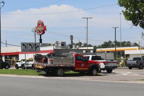 Columbia County Sheriff's Office and Columbia County Fire Rescue vehicles line the taped-off parking lot at Arby's on Thursday following a shooting at the restaurant. (JAMIE WACHTER/Lake City Reporter)