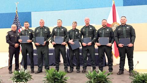 The Gainesville Police Department honored 12 Columbia County deputies and six communication officers on Friday with Police Service Awards for their help in capturing a fleeing murder suspect last year. (COURTESY)