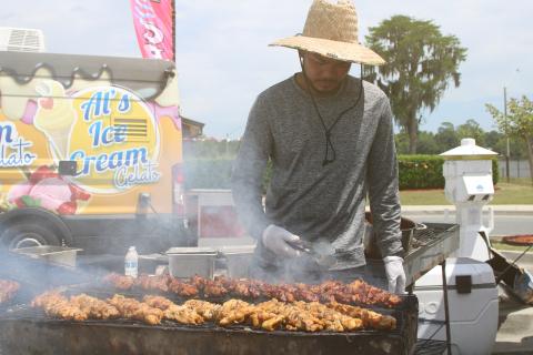 Auman Tamesis of Maya’s Merienda tends a variety of Filipino street food on the grill during the inaugural Multicultural Fiesta last year. The City of Lake City’s second Multicultural Day celebration is set for Saturday. (FILE)