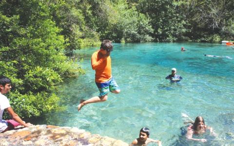 Dariel Garcia leaps into water at Ichetucknee Springs State Park during Labor Day weekend in 2022. (FILE)