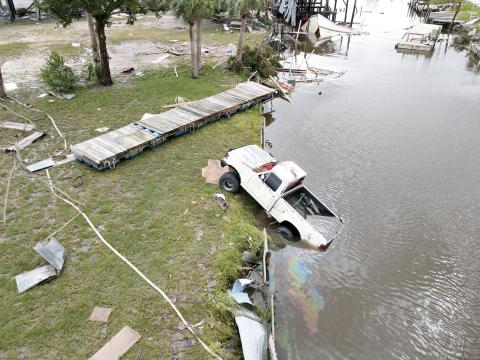 In Horseshoe Beach, near where Hurricane Idalia made landfall, a drone image shows a displaced vehicle spewing gasoline into a neighborhood canal. (MAX CHESNES/Tampa Bay Times/TNS)