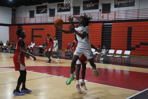 Fort White guard Tylan James goes for a reverse layup in Fort White’s summer league opener Thursday against Williston. (MORGAN MCMULLEN/Lake City Reporter)