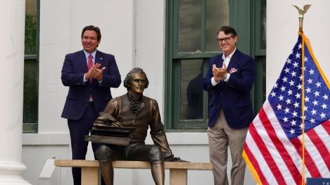 Florida Gov. Ron DeSantis (left) and Secretary of State Cord Byrd applaud the unveiling of a statue of Thomas Jefferson in Jefferson County on Wednesday as part of a new initiative to acquire statues of different counties’ namesakes. (COURTESY)