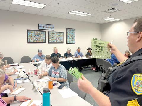 Sgt. Mike Lee with the Lake City Police Department shows members of a previous Citizen’s Police Academy the techniques used in investigating a traffic accident. (COURTESY)