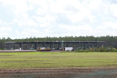 Work continued Friday on the 48,335-square-foot facility for AgroLiquid at the North Florida Mega Industrial Park. The grass parcel in front of the AgroLiquid facility is being eyed by a foreign steel manufacturer, according to county officials. (TONY BRITT/Lake City Reporter)