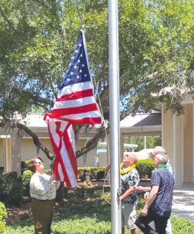 Volunteers raise the American flag outside of Haven Hospice. (COURTESY)
