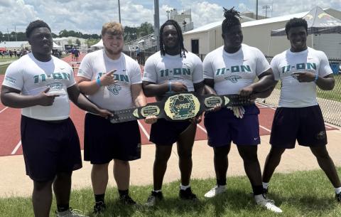 Columbia defensive lineman Jaden McCray (from left), offensive lineman Zackery Grimes, defensive lineman Jaylen Underwood, offensive lineman De’Manuel Jones and fullback Josiah Rossin celebrate with their championship belt after winning the linemen challenge at the Jaguars 11-ON on Thursday. (COURTESY)