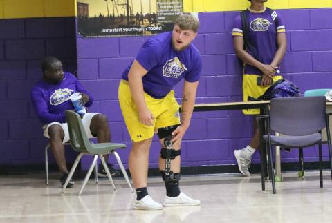 Columbia center Zackery Grimes watches practice inside the CHS gym on Monday after he recovers from tears to his ACL, MCL and meniscus in his knee. (JORDAN KROEGER/Lake City Reporter)
