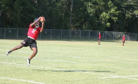 Fort White running back Elijah Gardner leaps to make a catch on a crossing route during Monday’s practice. (MORGAN MCMULLEN/Lake City Reporter)