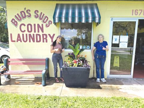 Hamilton County Director of Tourism Mia Hunter Mauldin (left) and Carol Stob, the owner of Bud’s Suds, pose next to a finished planter. (COURTESY)