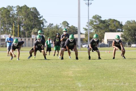 Suwannee quarterback Thomas Sikes gets set to take a snap behind offensive linemen Dalton Crossno (from left), Brody Bean, Blayne Crews, Reese Bronson and Colton Hagedorn during Monday's practice. (JAMIE WACHTER/Lake City Reporter)