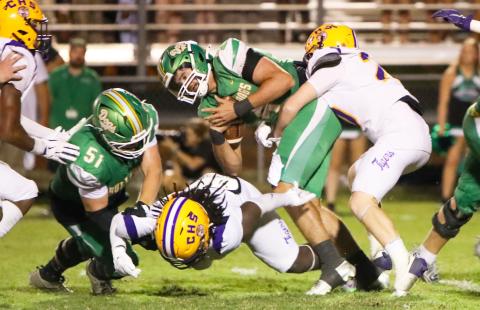 Suwannee quarterback Thomas Sikes is wrapped up by Columbia linebacker Bryson Grinstead on Friday night at Langford Stadium. (BRENT KUYKENDALL/Lake City Reporter)