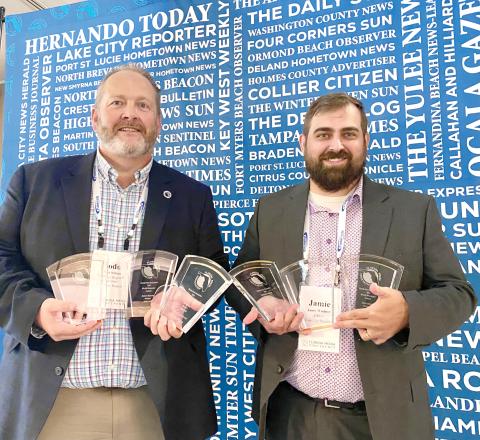 Lake City Reporter Publisher Todd Wilson (left) and Editor Jamie Wachter hold up the first-place awards that the Reporter and sister publication Nassau County Record captured last week in the Florida Press Association Weekly Newspaper Contest. (COURTESY)
