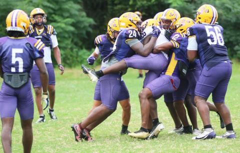 Columbia's defense swarms to tackle running back Jerome Horne during Thursday's practice. (JORDAN KROEGER/Lake City Reporter)