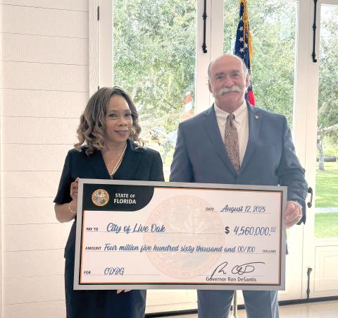 Live Oak City Manager Larry Sessions (right) and Councilwoman Vanessa Brown Robinson were in Arcadia last Thursday to receive a ceremonial $4.5 million check from the State of Florida. The funding will go toward water system improvements and home repairs for low-income families. (COURTESY)