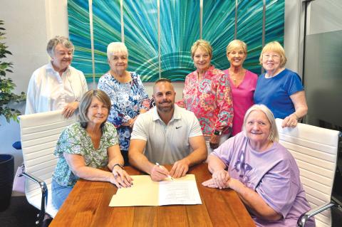 Josh Sparks, owner of Sparks Construction, is pictured with members of the Lake City Women’s Club and Lake City Garden Club, after signing the deed to the historic Club House on Lake Isabella. Sparks was given ownership of the building so he can repair and save the facility. (COURTESY)