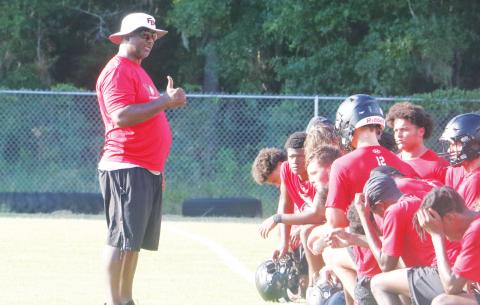 Fort White head coach Demetric Jackson speaks to his team following practice on July 28. (MORGAN MCMULLEN/Lake City Reporter)