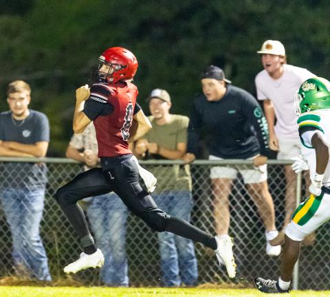Lafayette receiver Parker Hill outruns the Suwannee defense for the game-winning touchdown on Friday. (JACK HOWDESHELL/Lake City Reporter)