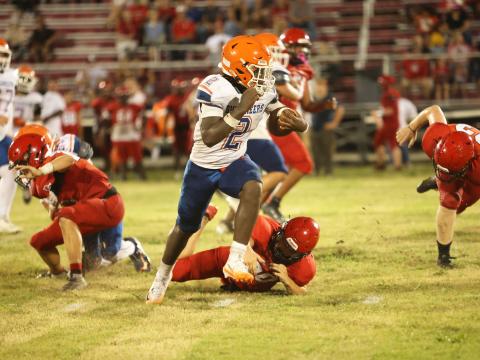 Branford running back Ollie James runs past a Dixie County defender Friday night during their Preseason Classic. (PAUL BUCHANAN/Lake City Reporter)