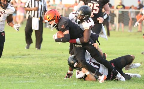 Fort White linebackers Cameron Lumpkin (17) and Teagin Bell (11) combine for a tackle on Trenton running back Brant Bivens during Friday’s Preseason Classic. (MORGAN MCMULLEN/Lake City Reporter)