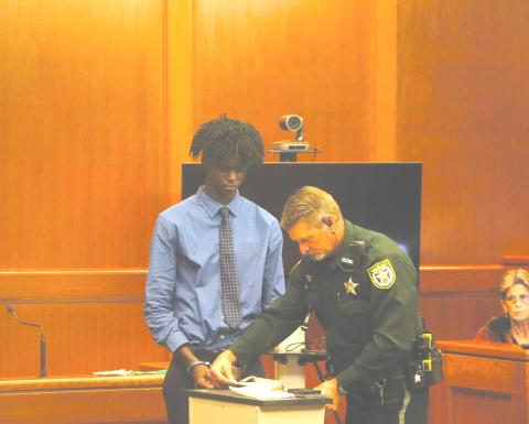 Jayden Burch is fingerprinted after being found guilty of murder and attempted murder on Wednesday in a 2023 shooting that killed 12-year-old Mariah Smith. (MORGAN MCMULLEN/Lake City Reporter)