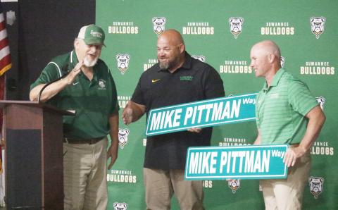 Legendary former Suwannee coach Mike Pittman was surprised at Friday’s celebration with the naming of the road adjacent to Langford Stadium as Mike Pittman Way. Pittman is pictured with SHS assistants Clifford Bean and Todd Frier, who both played under Pittman. (JAMIE WACHTER/Lake City Reporter)