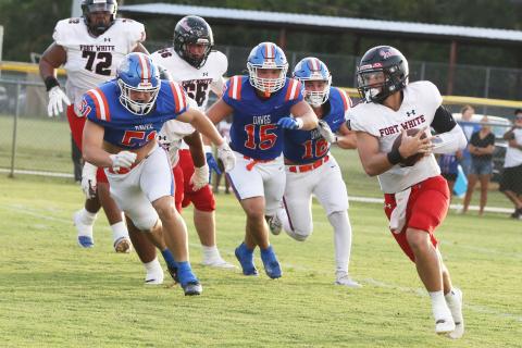 Fort White quarterback Matthew Pitts scrambles on the opening drive of Friday’s 20-3 loss at Taylor County. (MORGAN MCMULLEN/Lake City Reporter)