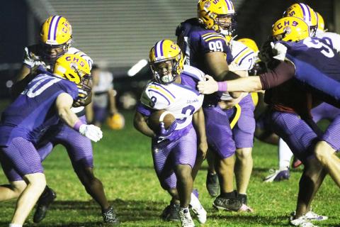 Columbia running back Jeffery Pope tries to break a tackle from defensive end Kyten Davis during Monday's practice. (JORDAN KROEGER/Lake City Reporter)