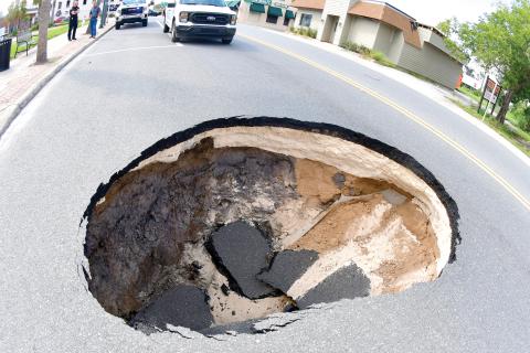 A sinkhole opened up Monday afternoon in the eastbound lane of E. Howard Street (U.S. Highwy 90) in downtown Live Oak near the intersection with Dowling Avenue. Florida Department of Transporation crews repaired the problem Monday night and the street has been reopened. (ROB WOLFE/Lake City Reporter)