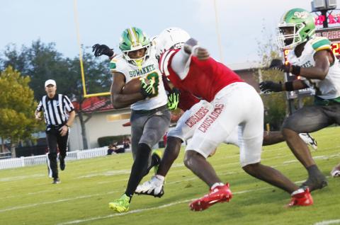 Suwannee running back Lou Jack Smith gets stuffed by a pair of Bishop Kenny defenders during Friday’s Preseason Classic. (JAMIE WACHTER/Lake City Reporter)
