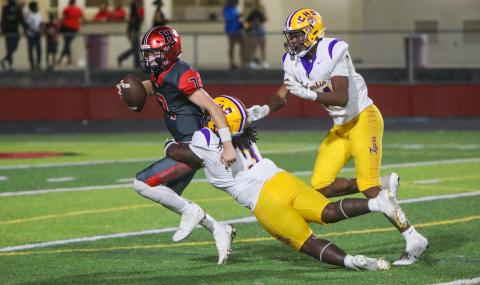 Columbia defensive lineman Terry Henry takes down Hillsborough quarterback Ethan Hanson for one of his three sacks on Friday. (BRENT KUYKENDALL/Lake City Reporter)