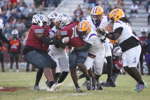 Columbia defensive tackle Jaden McCray tackles Madison County quarterback Chad Mitchell on Friday. (BRENT KUYKENDALL/Lake City Reporter)
